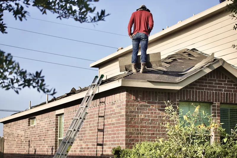 Professional roofer working on a residential roof in Seneca-Sun Valley
